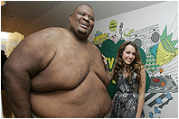 Hannah Montana / Miley Cyrus and a rather large gentleman
